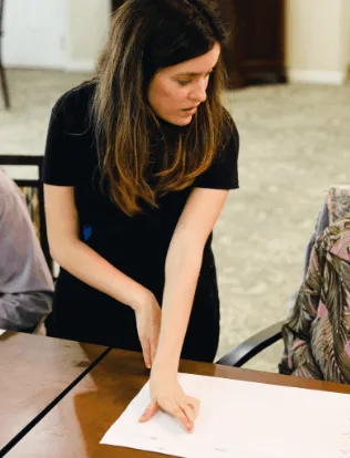 Researcher guiding a co-creation workshop activity at a table