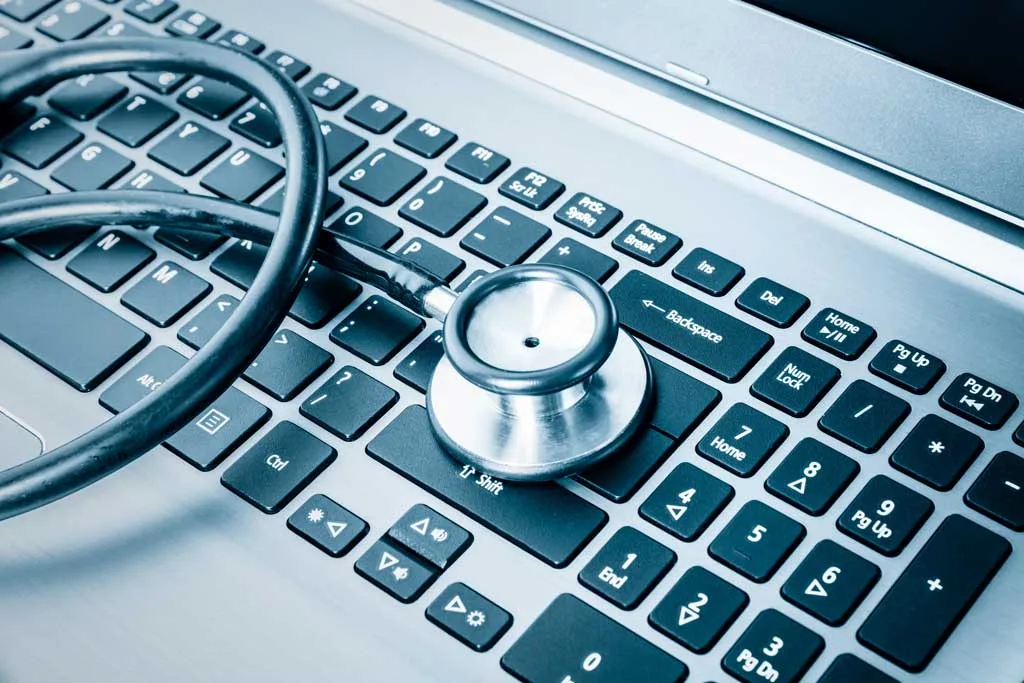 Stethoscope placed on top of a computer keyboard denoting the idea of software in healthcare