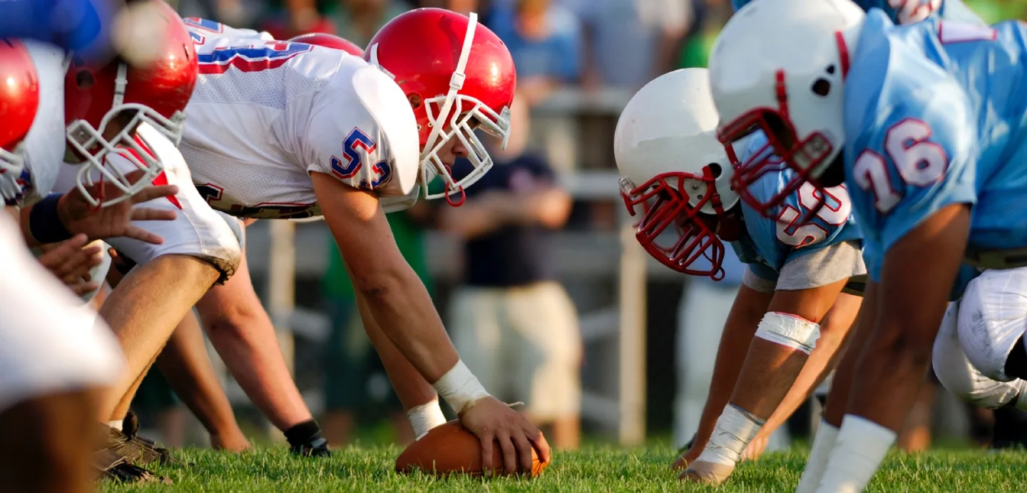 High school football players at the line of scrimmage