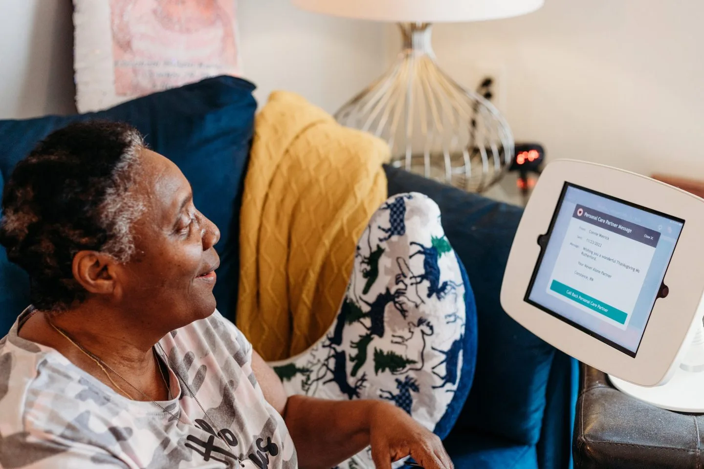Patient using NeverAlone telehealth platform from home