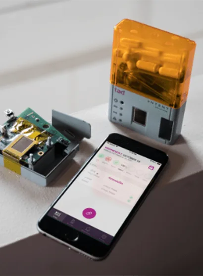 Intent Solutions tad smart pill bottle device alongside the companion mobile app