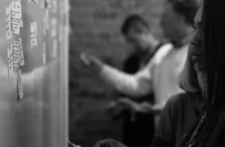 Discovery workshop with sticky notes on a wall during early NeverAlone planning