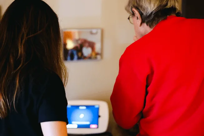 Usability testing session with older adult using NeverAlone tablet