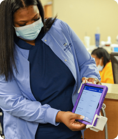 Healthcare worker showing a patient a MVP development application