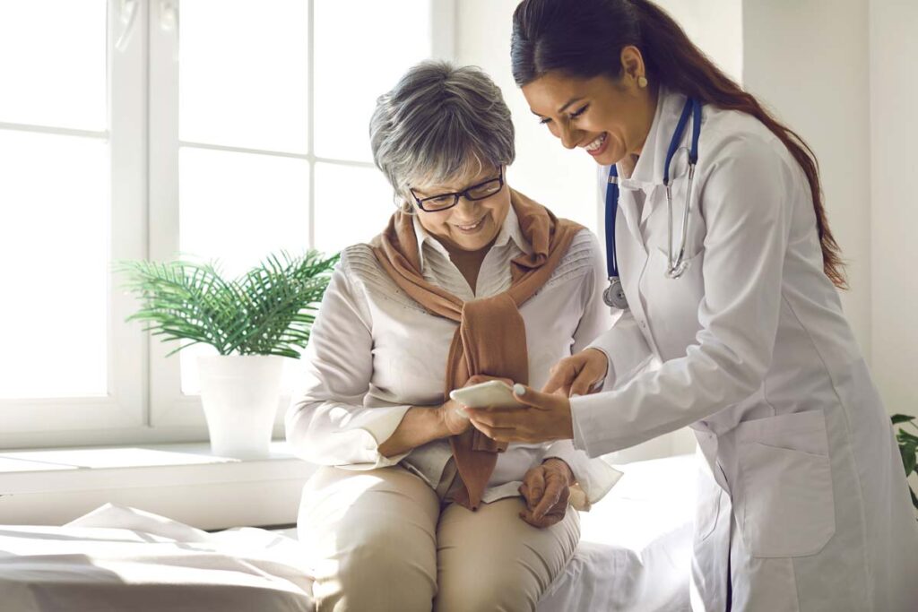 A doctor showing a patient how to use an app